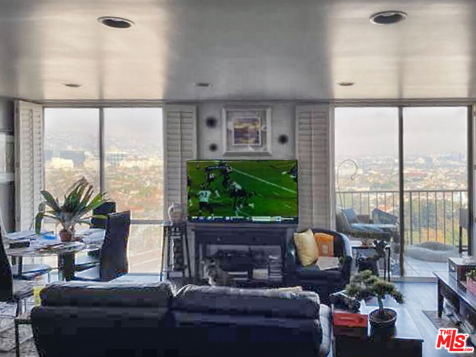 2170 Century Park East, Unit 1611 Los Angeles, CA 90067 - Photo 2 of 41 a living room with fireplace furniture and a large window
