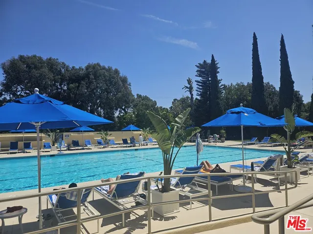 a view of a patio with chairs under an umbrella