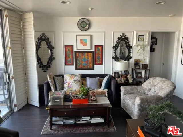 a living room with furniture and a mirror