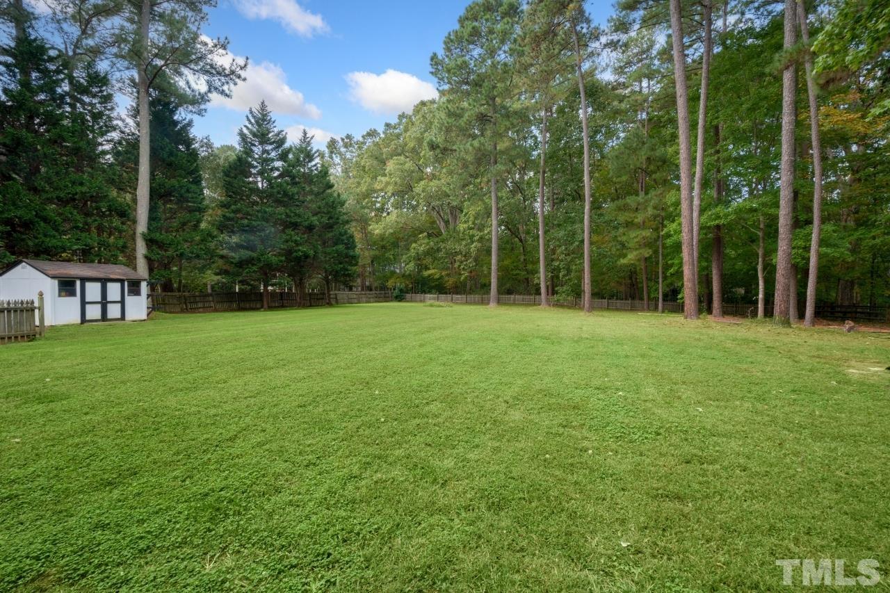11915 Shooting Club Road Raleigh, NC 27613 - Photo 3 of 8 a backyard of a house with trampoline