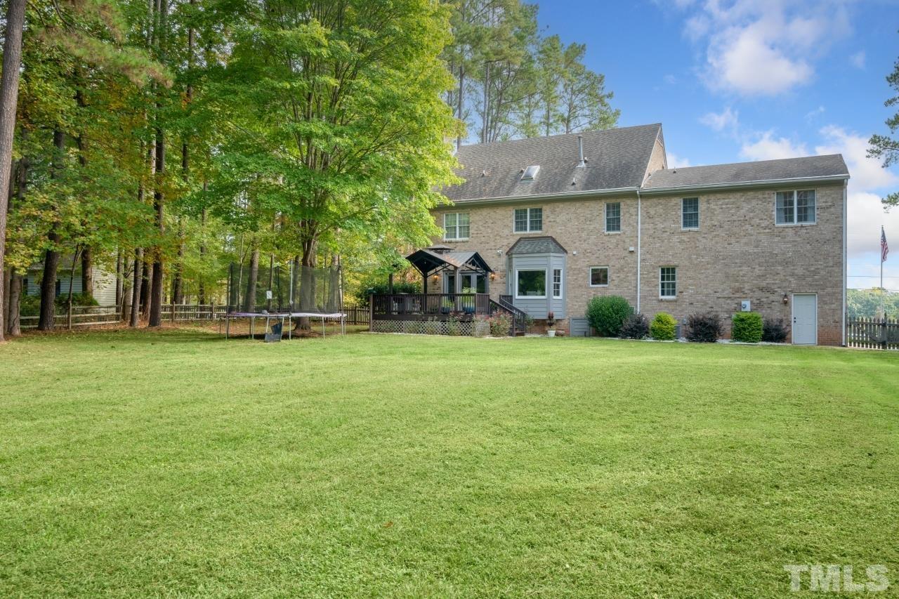 11915 Shooting Club Road Raleigh, NC 27613 - Photo 4 of 8 a front view of house with yard and green space