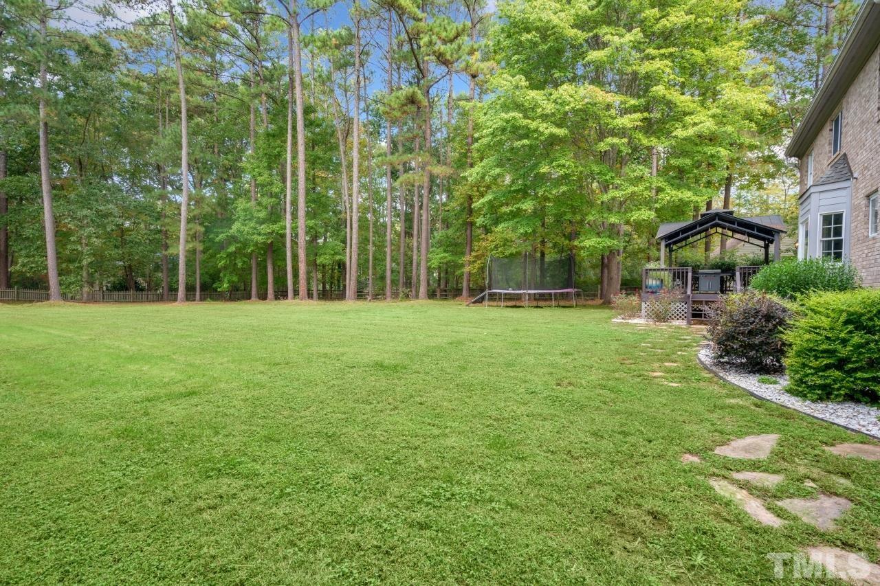 11915 Shooting Club Road Raleigh, NC 27613 - Photo 5 of 8 a backyard of a house with lots of green space