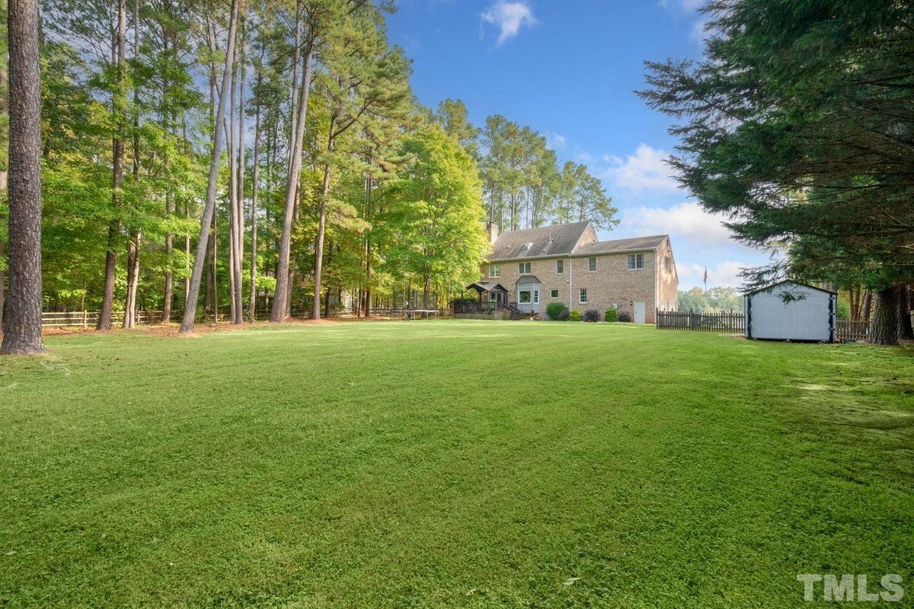 11915 Shooting Club Road Raleigh, NC 27613 - Photo 6 of 8 a front view of a building with garden