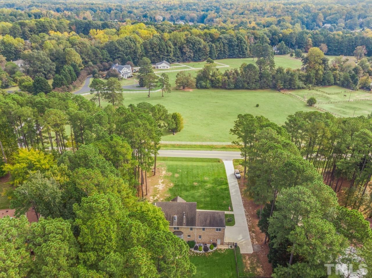 11915 Shooting Club Road Raleigh, NC 27613 - Photo 7 of 8 a view of a lake with a house