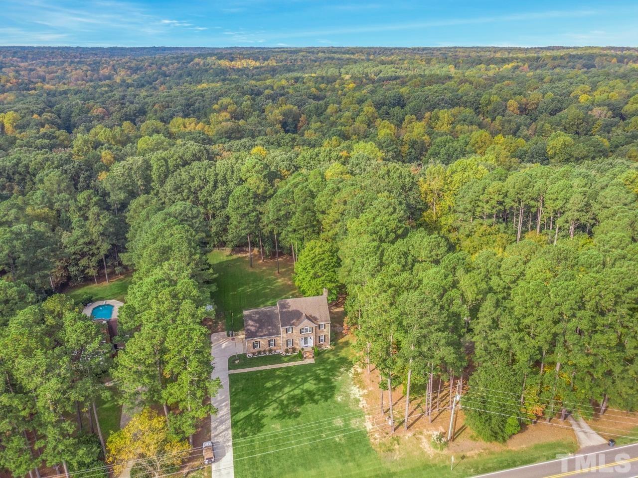 11915 Shooting Club Road Raleigh, NC 27613 - Photo 8 of 8 a view of a city with lush green forest
