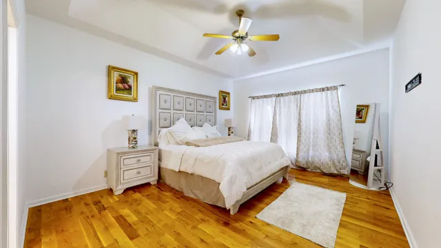 a bedroom with a bed and a chandelier