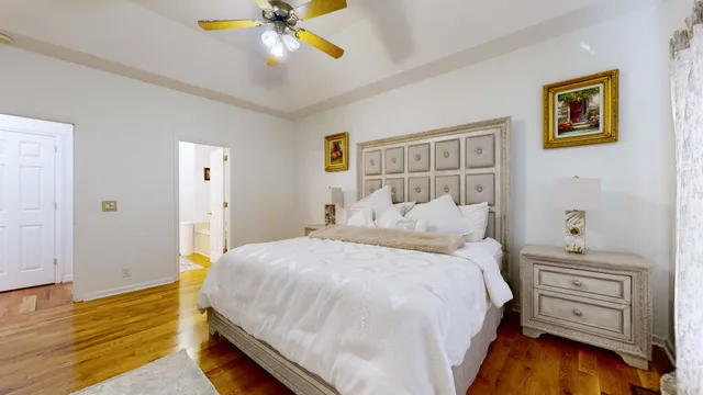 a bedroom with a bed and a chandelier