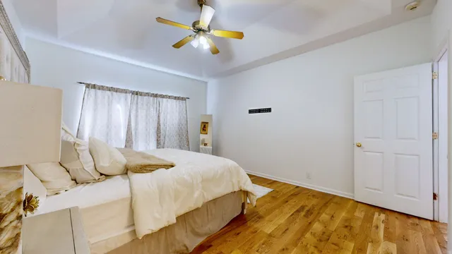 a bedroom with a bed and a chandelier