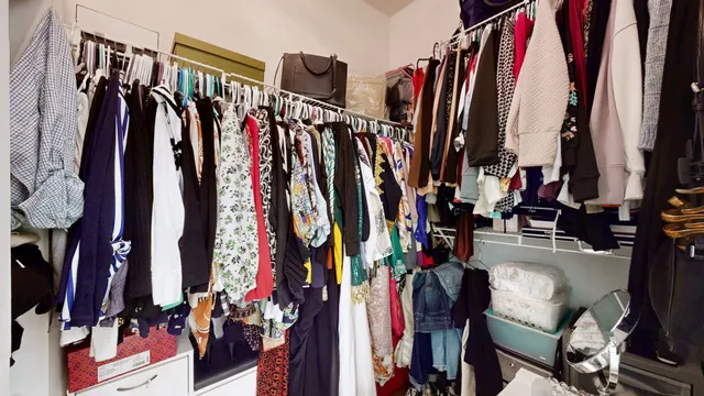 a view of walk in closet with clothes