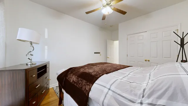 a bedroom with a bed and a chandelier