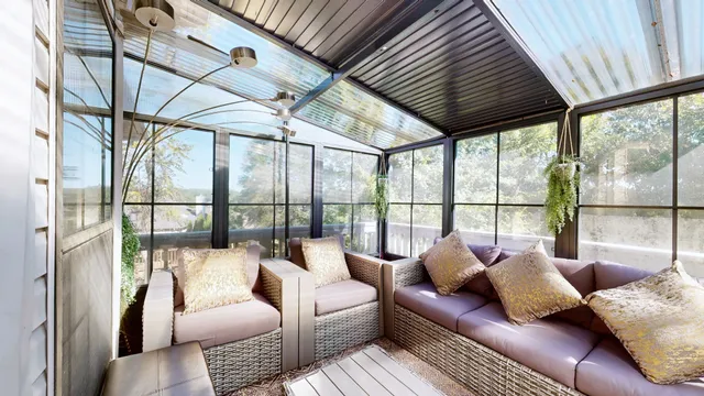 a living room with furniture and a floor to ceiling window