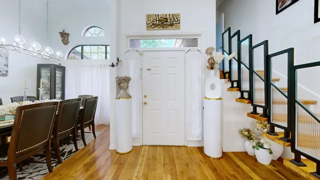 a view of a hallway with wooden floor and staircase