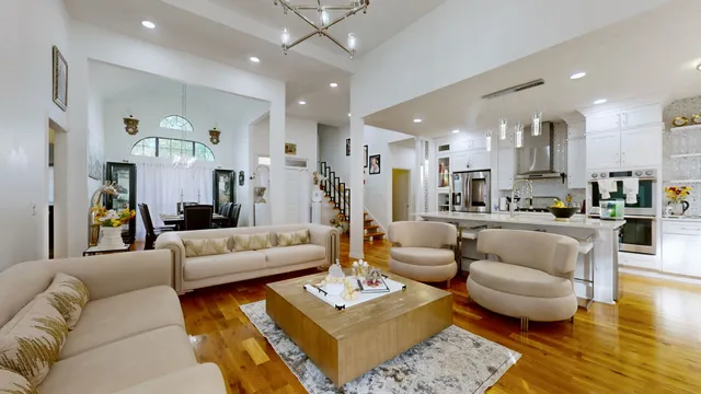 a living room with furniture and kitchen view