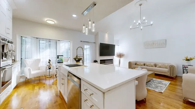a large white kitchen with a table and chairs