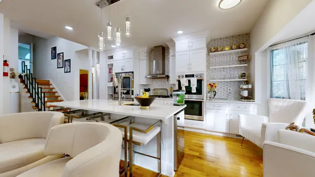 a living room with stainless steel appliances kitchen island granite countertop furniture and a view of kitchen
