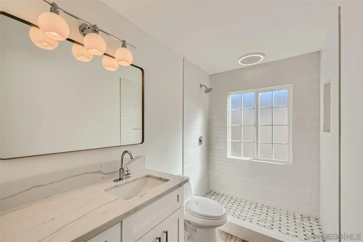 14222 Halper Road Poway, CA 92064 - Photo 15 of 30 a bathroom with a sink a toilet and a mirror