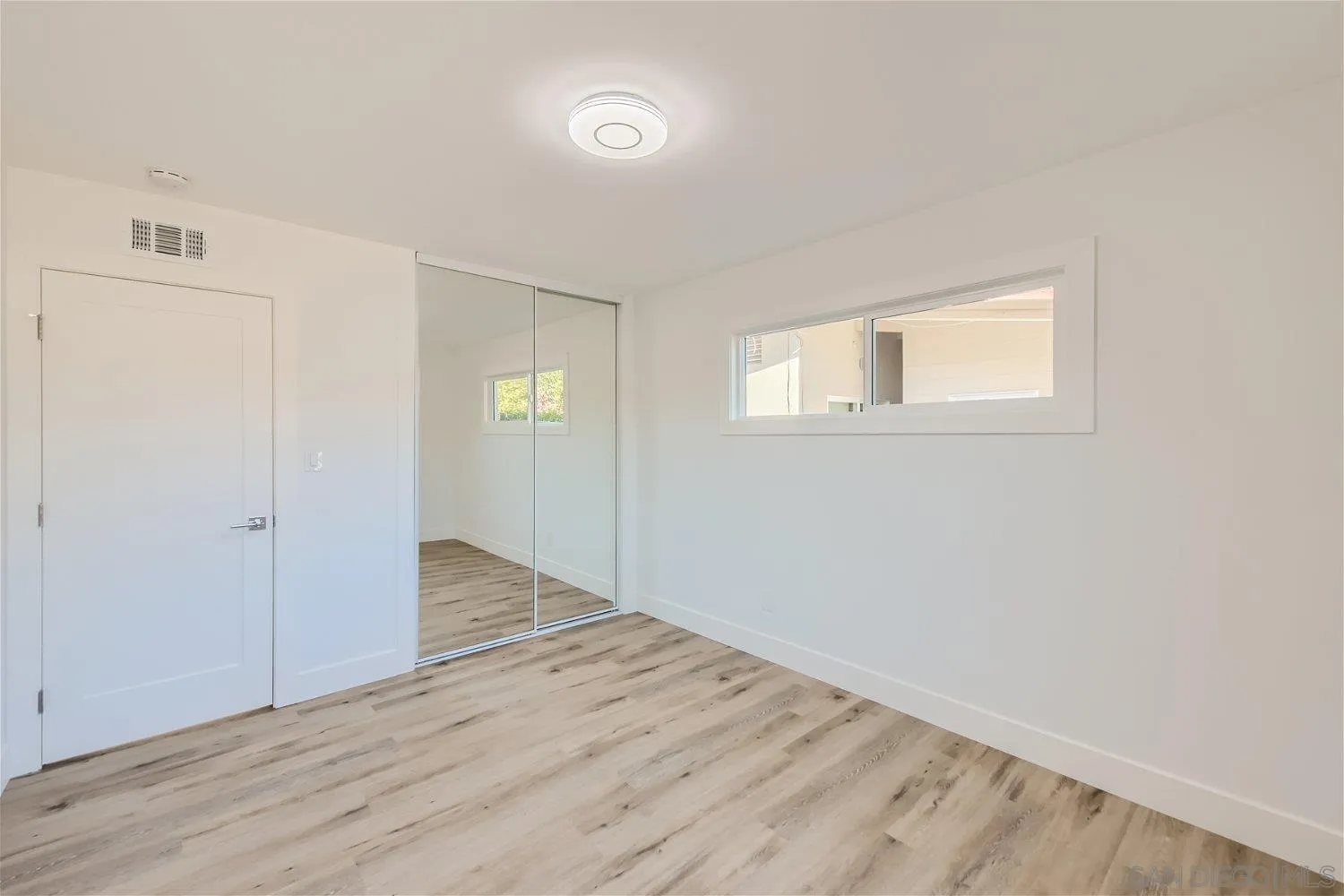 14222 Halper Road Poway, CA 92064 - Photo 19 of 30 an empty room with wooden floor and windows