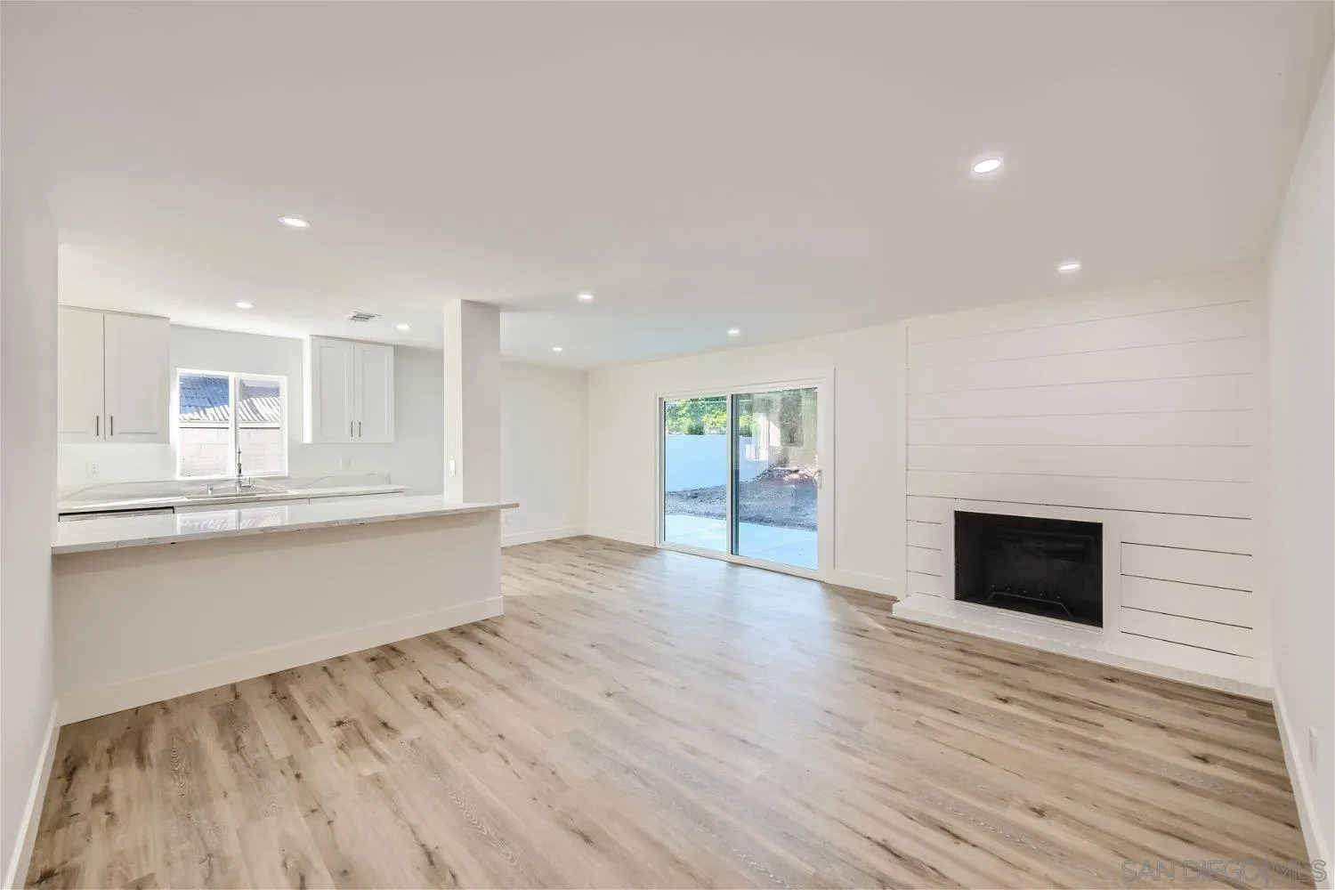 14222 Halper Road Poway, CA 92064 - Photo 3 of 30 a view of an empty room with wooden floor and a window