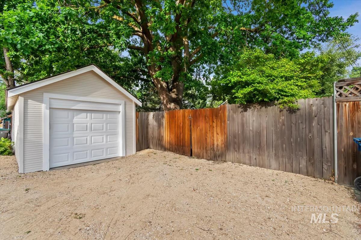 910 North 16th Street Boise, ID 83702 - Photo 37 of 47 Detached garage featuring a white panel door, light-colored siding, and a gable roof