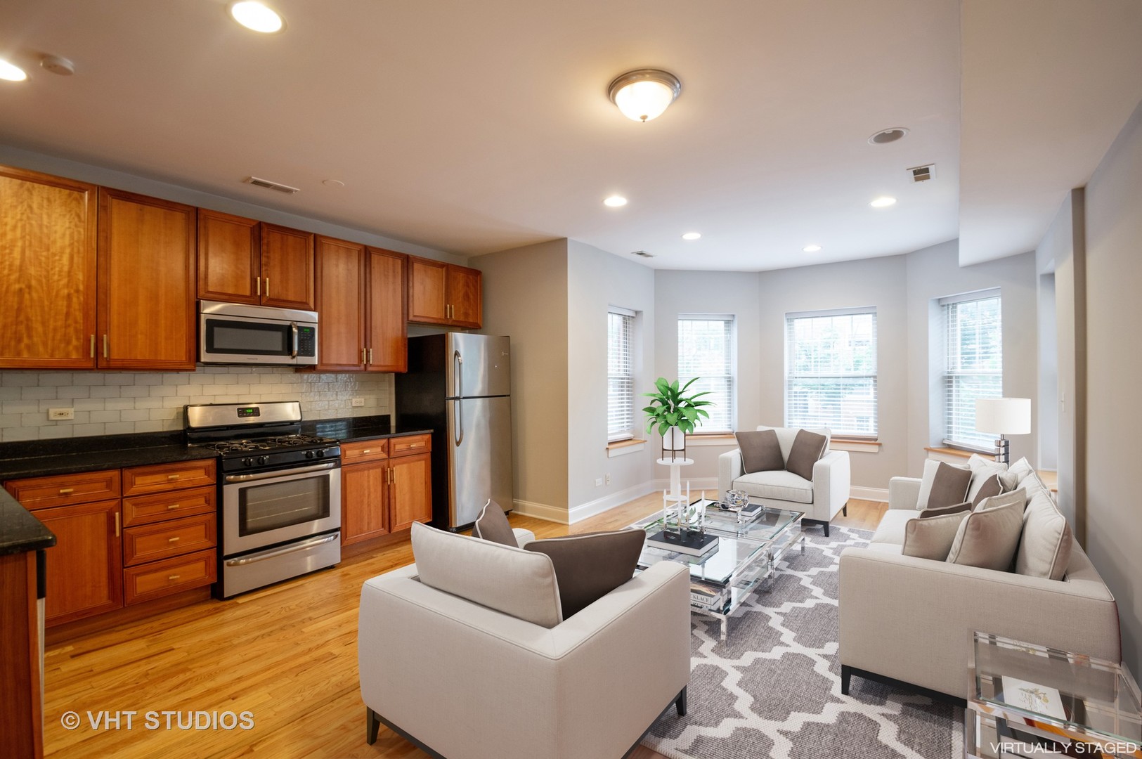 4855 North Drake Avenue, Unit 1 Chicago, IL 60625 - Photo 2 of 20 a living room with furniture wooden floor and a kitchen view