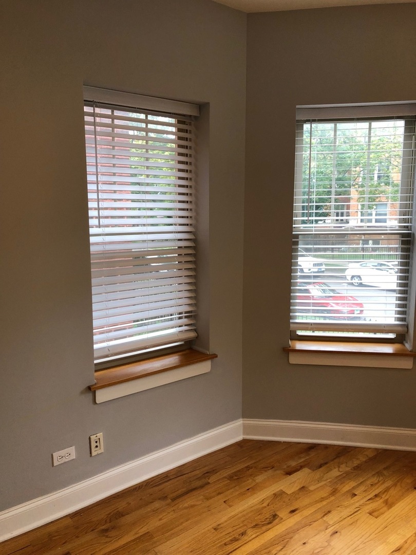 4855 North Drake Avenue, Unit 1 Chicago, IL 60625 - Photo 14 of 20 a view of an empty room with wooden floor and a window