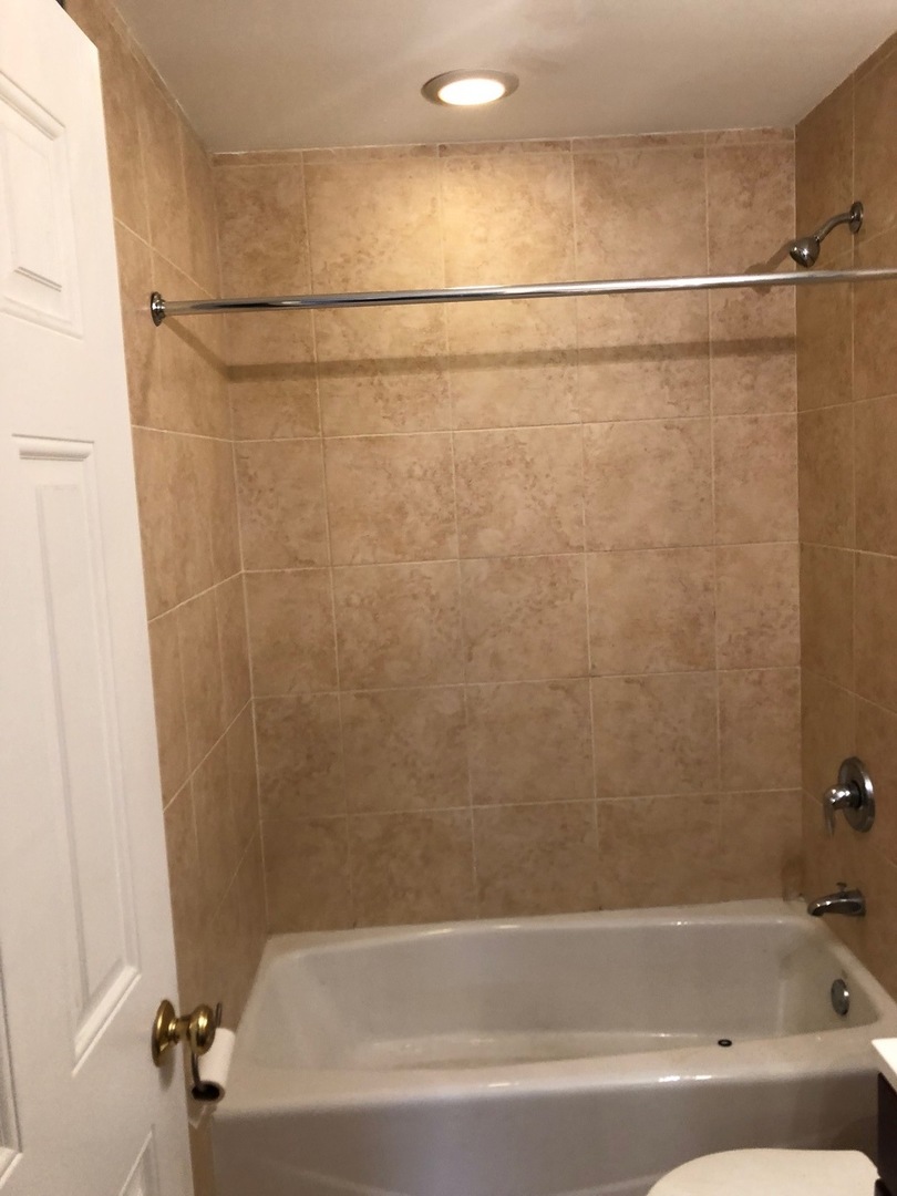 4855 North Drake Avenue, Unit 1 Chicago, IL 60625 - Photo 18 of 20 a bathroom with a shower and a bath tub