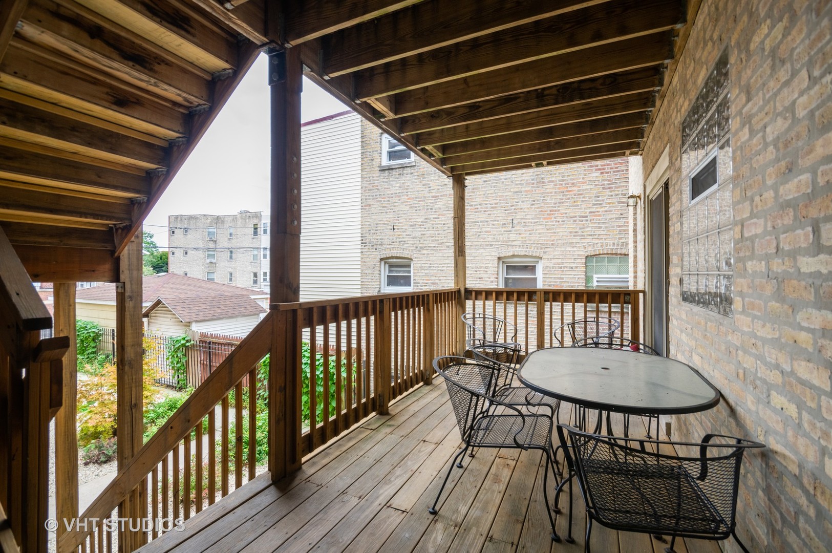 4855 North Drake Avenue, Unit 1 Chicago, IL 60625 - Photo 3 of 20 a view of a balcony with wooden floor