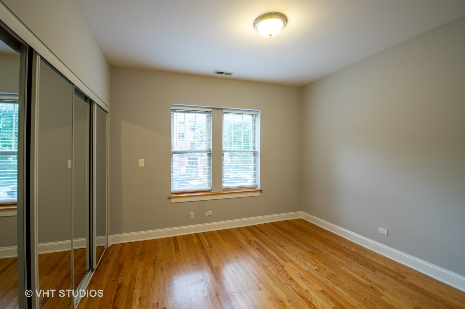 4855 North Drake Avenue, Unit 1 Chicago, IL 60625 - Photo 9 of 20 an empty room with wooden floor and windows