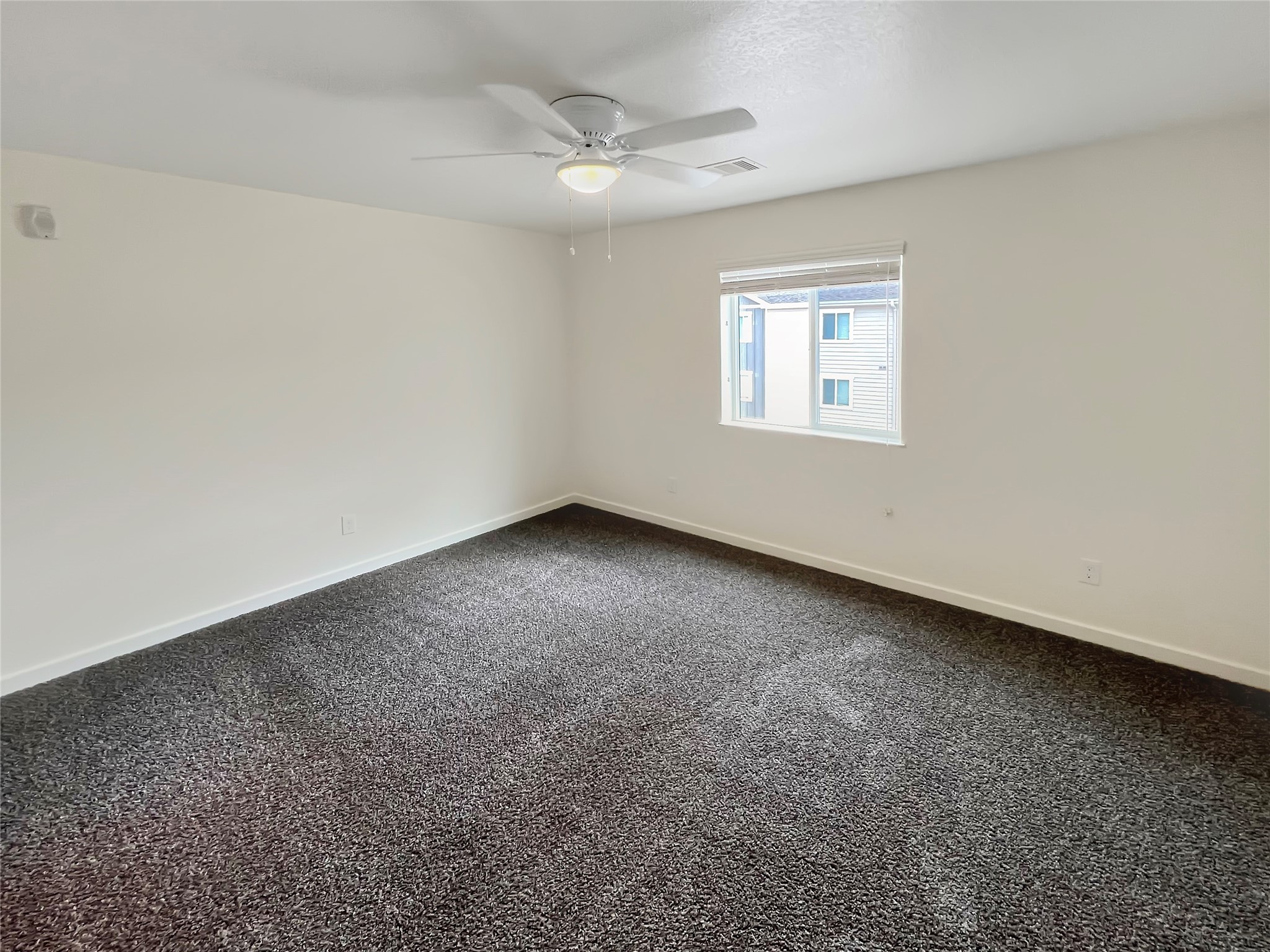 21155 Gosling Road, Unit 48 AD Spring, TX 77388 - Photo 18 of 20 an empty room with a ceiling fan and window