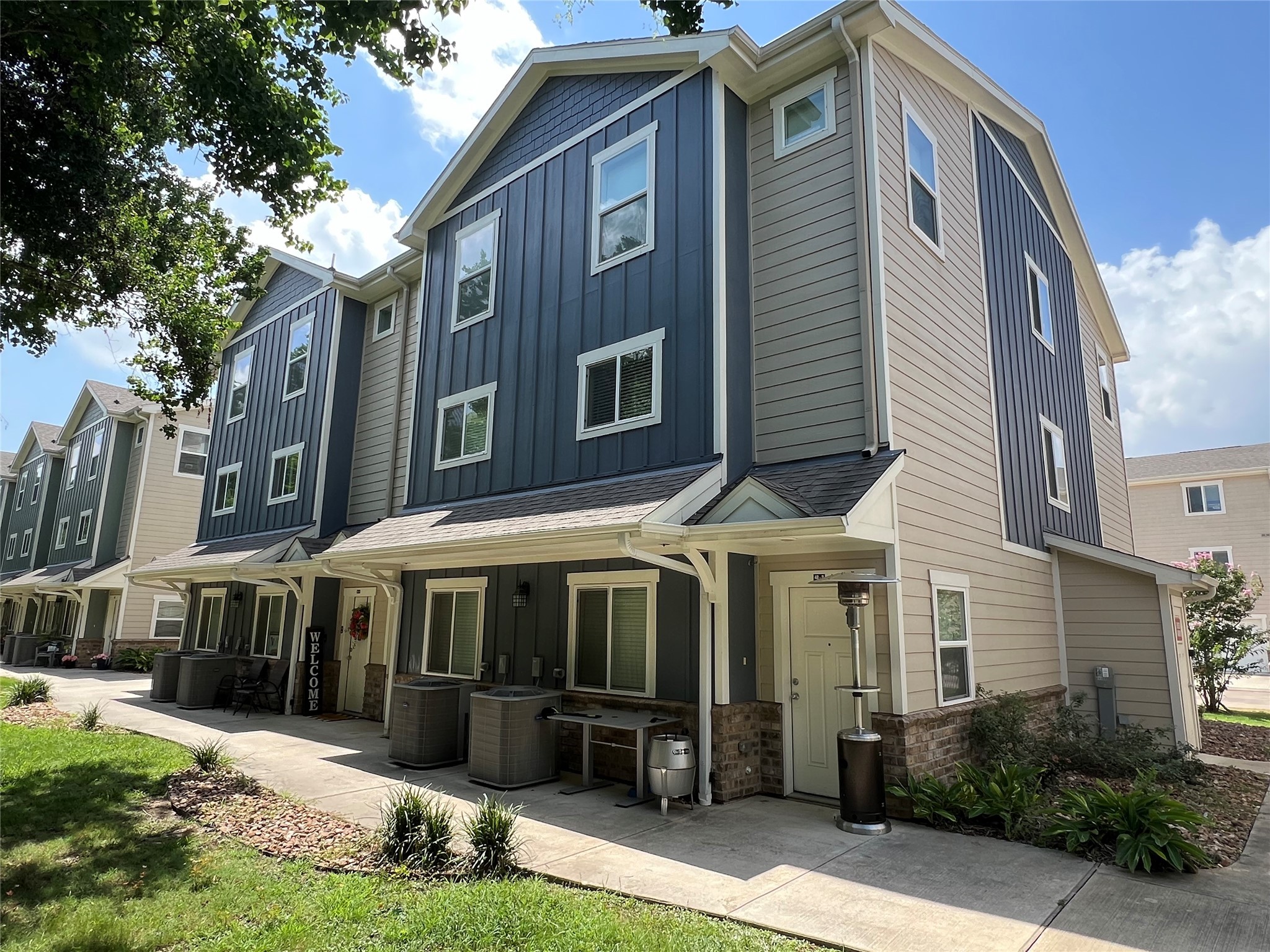 21155 Gosling Road, Unit 48 AD Spring, TX 77388 - Photo 3 of 20 a front view of a building with a garden