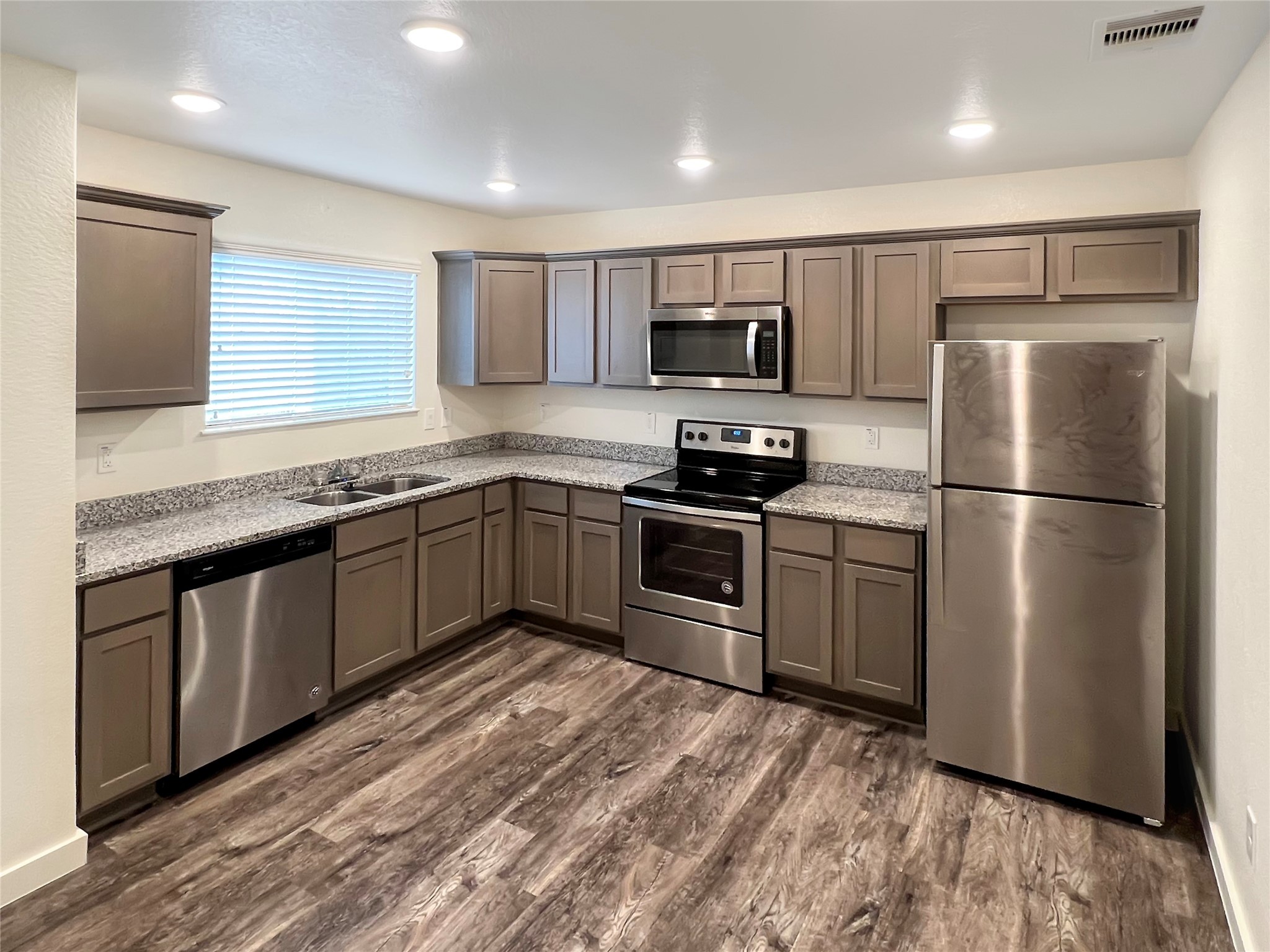 21155 Gosling Road, Unit 48 AD Spring, TX 77388 - Photo 10 of 20 a kitchen with stainless steel appliances granite countertop a refrigerator a sink dishwasher a stove top oven a refrigerator with island and chairs