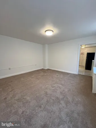 an empty room with a empty space and windows