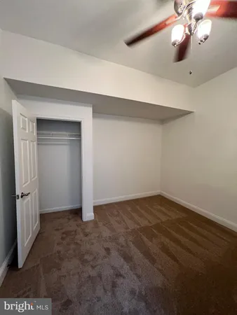 en empty room with windows and fan