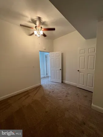 a view of room with window and ceiling fan