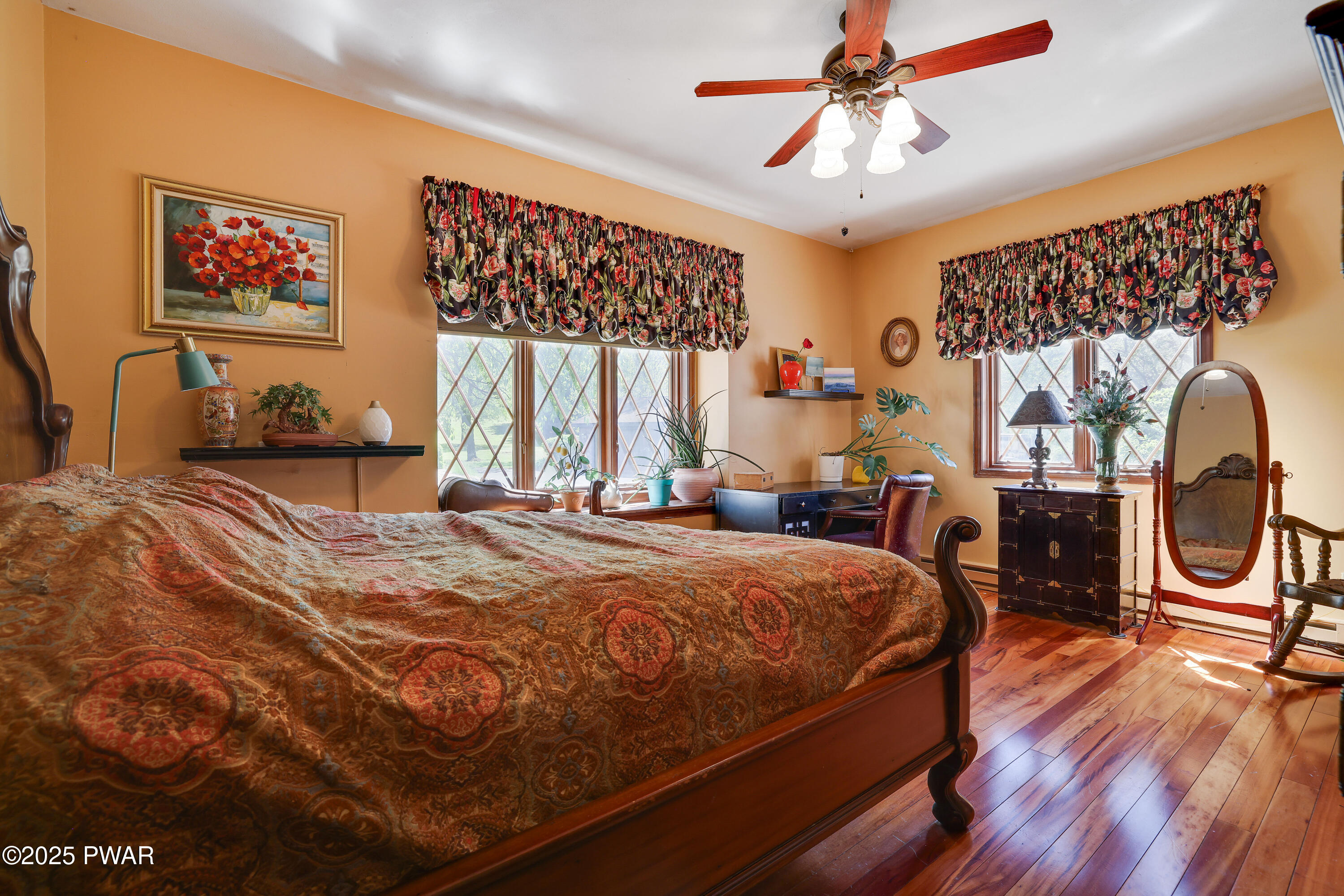 555 Valley View Road Dallas, PA 18612 - Photo 40 of 99 a bedroom with a bed a dresser and painting on the wall