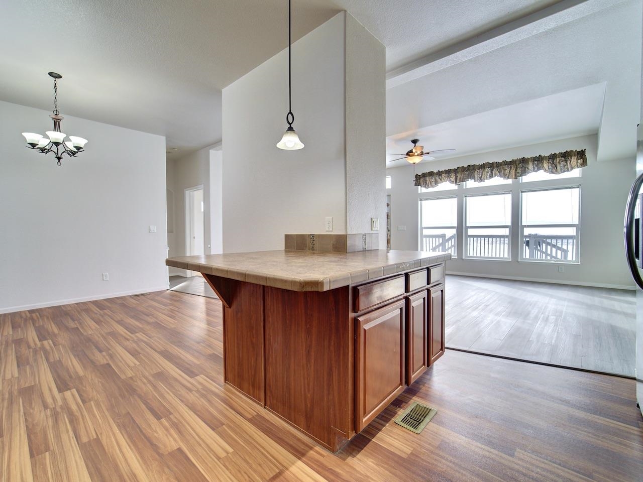 2423 16 Road Loma, CO 81524 - Photo 11 of 38 a kitchen with granite countertop a stove a sink and a wooden floors