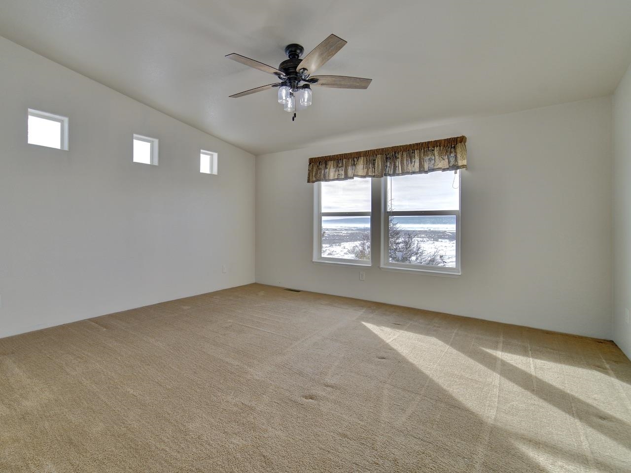 2423 16 Road Loma, CO 81524 - Photo 16 of 38 an empty room with windows and ceiling fan