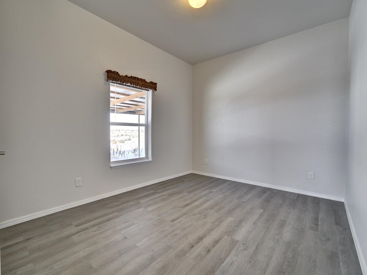 2423 16 Road Loma, CO 81524 - Photo 20 of 38 an empty room with wooden floor and windows
