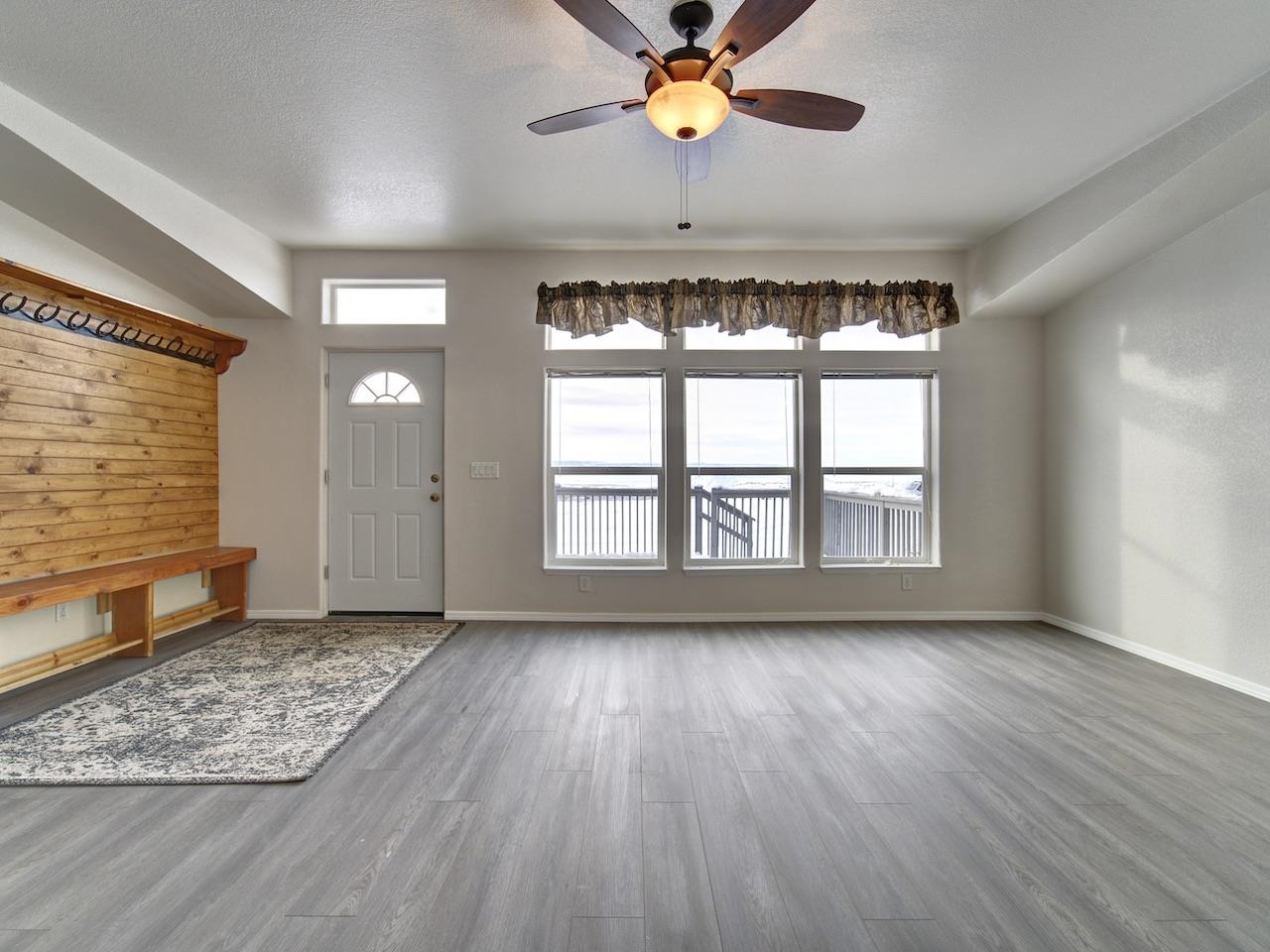2423 16 Road Loma, CO 81524 - Photo 3 of 38 a view of an empty room with a window and wooden floor
