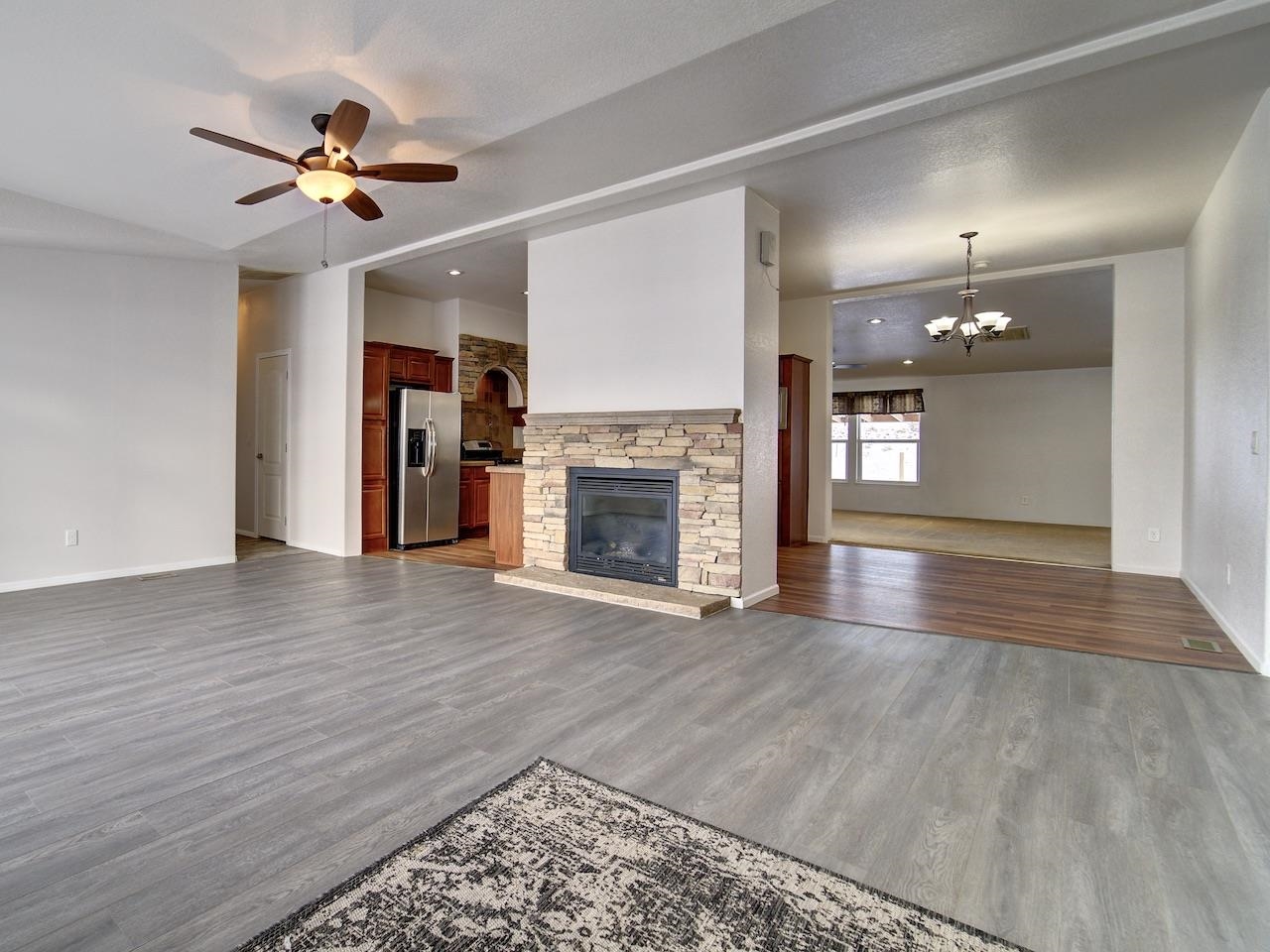 2423 16 Road Loma, CO 81524 - Photo 6 of 38 wooden floor in an empty room with a fireplace