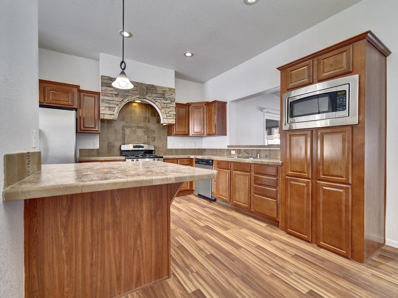2423 16 Road Loma, CO 81524 - Photo 7 of 38 a kitchen with stainless steel appliances kitchen island granite countertop a stove a sink and a refrigerator