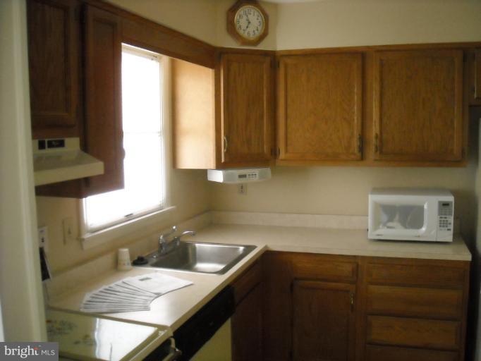 1215 Roxboro Road Rosedale, MD 21237 - Photo 16 of 29 a kitchen with a sink cabinets and a window