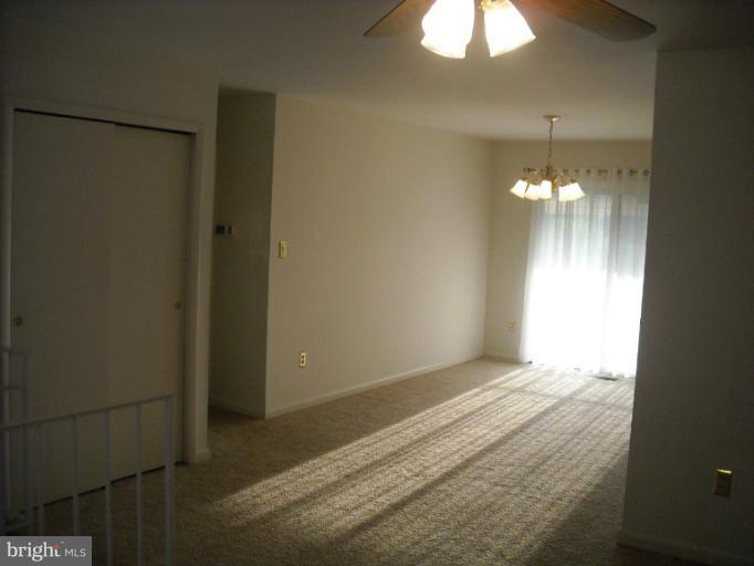 1215 Roxboro Road Rosedale, MD 21237 - Photo 8 of 29 a view of an empty room with window and chandelier fan