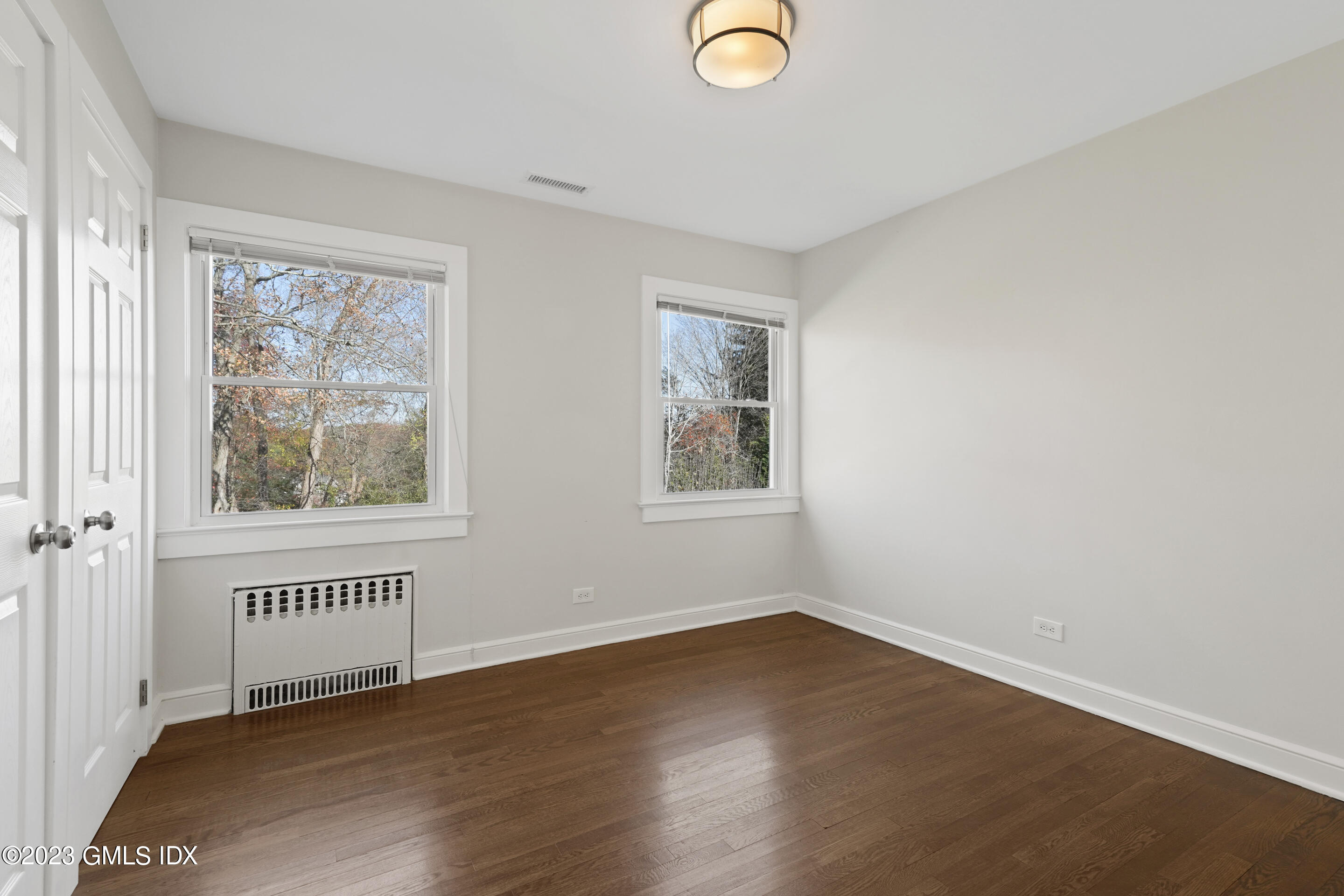 2279 High Ridge Road Stamford, CT 06903 - Photo 11 of 22 a view of an empty room with a window and wooden floor