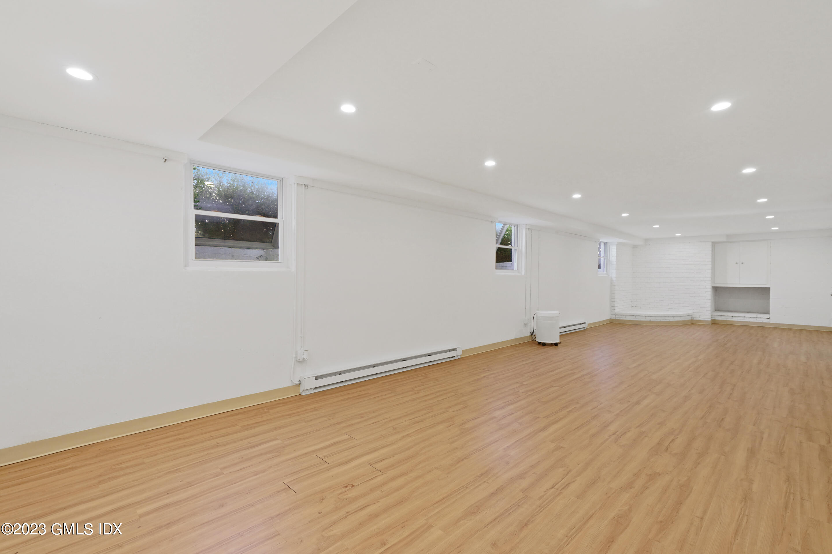 2279 High Ridge Road Stamford, CT 06903 - Photo 17 of 22 an empty room with wooden floor and windows