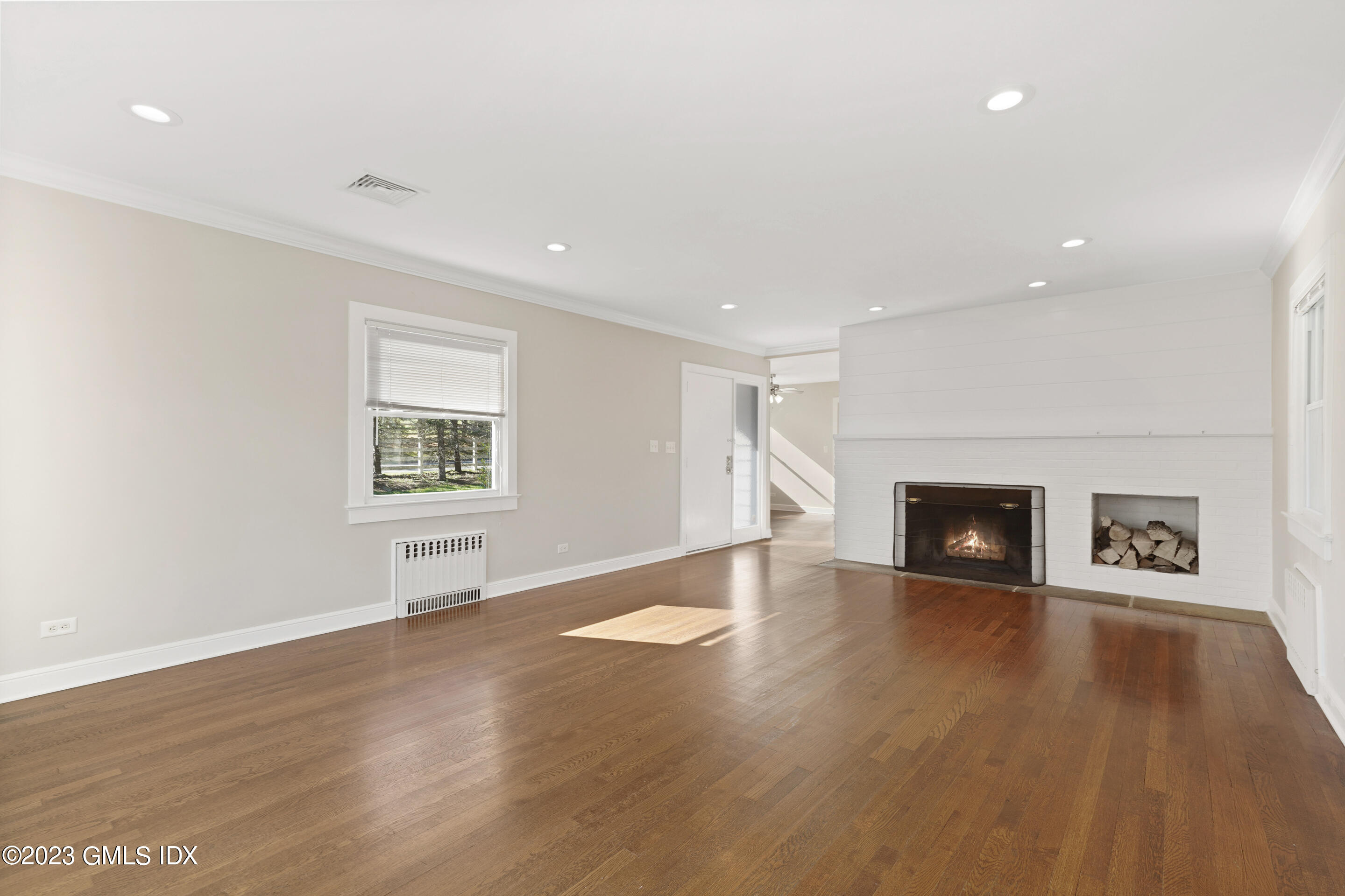2279 High Ridge Road Stamford, CT 06903 - Photo 3 of 22 an empty room with wooden floor and a fireplace