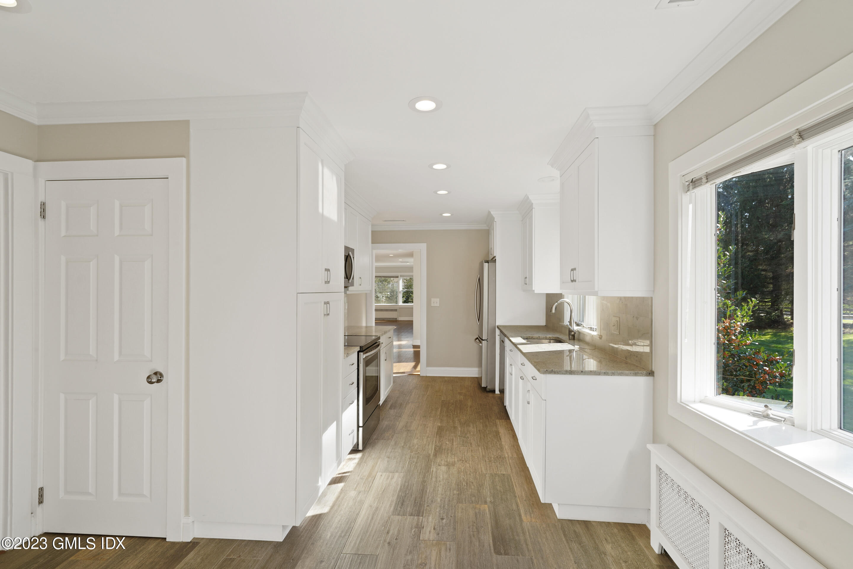 2279 High Ridge Road Stamford, CT 06903 - Photo 5 of 22 a view of a kitchen with a sink wooden cabinets and entryway