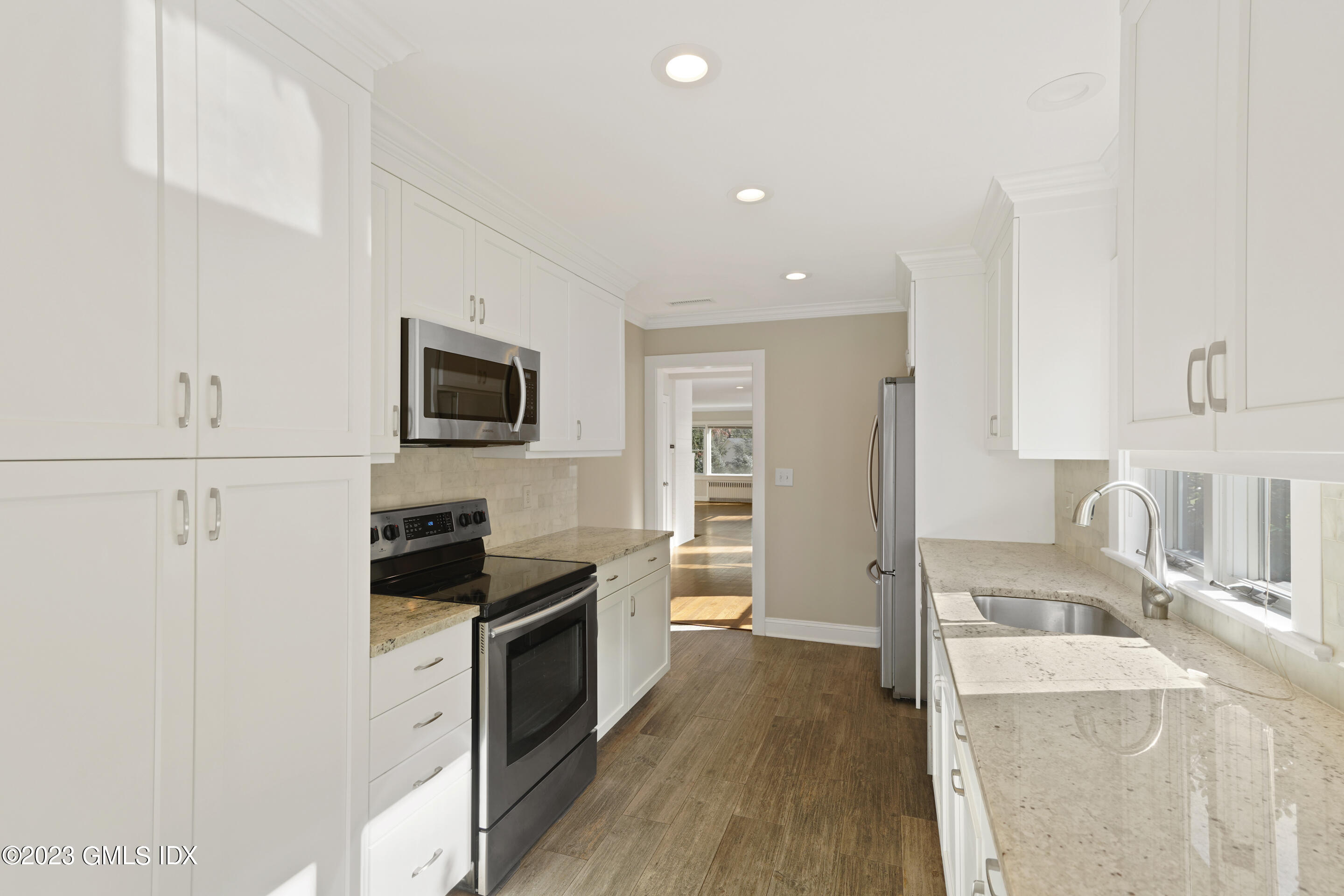 2279 High Ridge Road Stamford, CT 06903 - Photo 6 of 22 a kitchen with granite countertop a sink stove and refrigerator