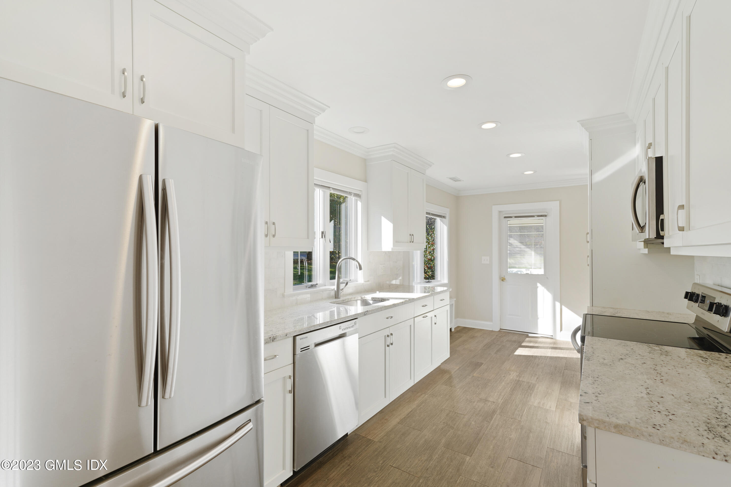 2279 High Ridge Road Stamford, CT 06903 - Photo 7 of 22 a large white kitchen with a sink and refrigerator