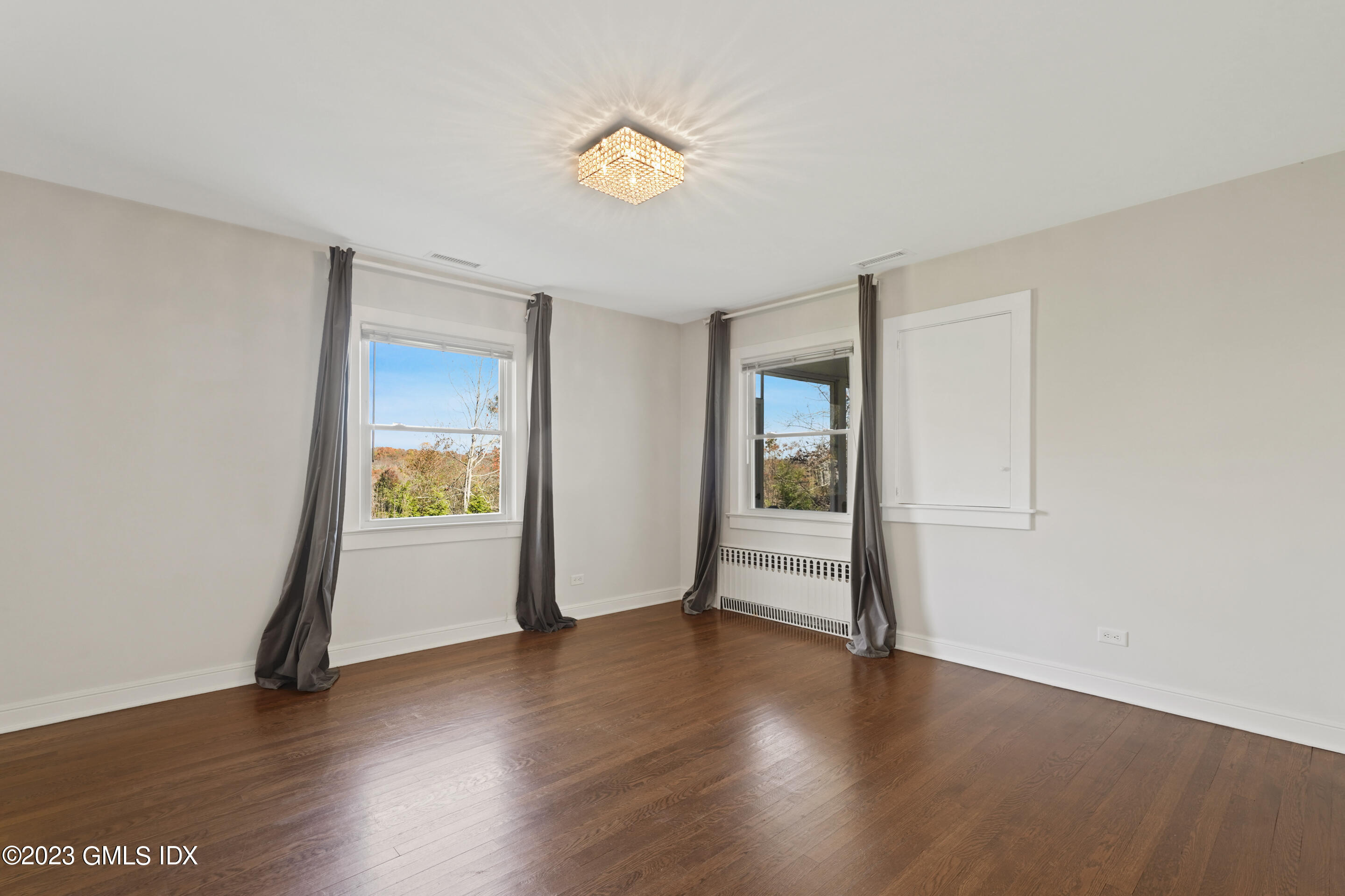 2279 High Ridge Road Stamford, CT 06903 - Photo 9 of 22 a view of an empty room with window and wooden floor